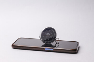 Smartphone with a compass on a gray background. Navigation