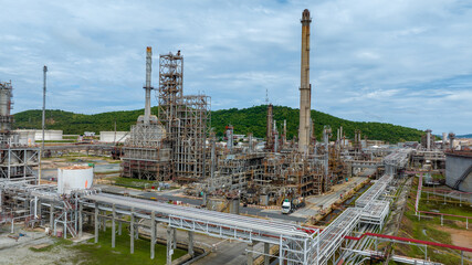 Fototapeta premium Oil Refinery Gas Chemical Equipment Prodiction import export Concept, Crude Oil Refinery Plant Steel Pump Pipe line and Tank and Cooling tower, Chemical or Petrochemical Factory plant, industry
