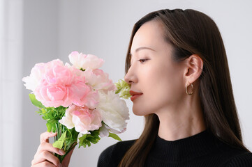 Pink flowers (ranunculus) and a beautiful Japanese woman