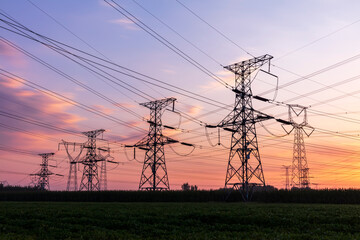 In the evening, the silhouette of high voltage towers