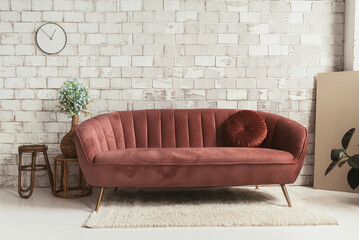 Modern furniture composition in soft colors on the background of a white brick wall