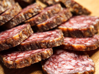 Meat appetizer. Dried sausage, close-up shot. Lots of sausage slices.