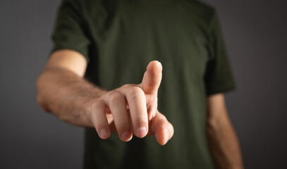 Pointing or touching finger in screen.