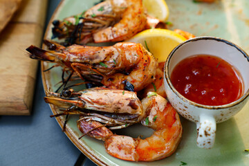 seafood. shrimp cooked on the grill with sauce and vegetables. 