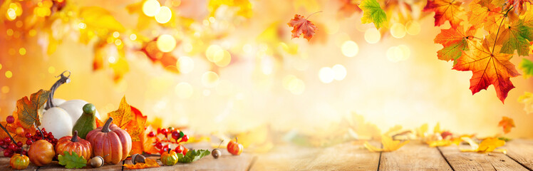 Autumn banner with fallen maple leaves and pumpkins on wooden vintage table. Autumn concept with red-yellow leaves background. Thanksgiving pumpkins. - obrazy, fototapety, plakaty