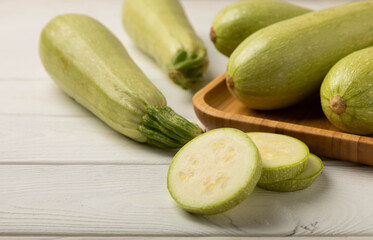 Slices of zucchini.Squash vegetable marrow zucchini on white texture background.Vegetarian organic vegetables.Healthy food.Copy space.Place for text.Healthy food concept.