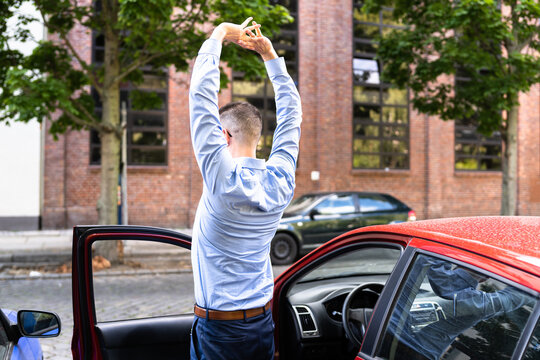 Car Driver Doing Stretch Exercise During Break