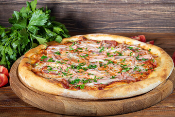 Pizza with bacon and cheese, herbs and cherry tomatoes. With mozzarella, shrimp and octopus, mussels and other products on a wooden background.