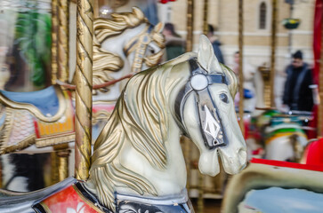 Fototapeta na wymiar The decorations on the children's carousel with wooden horses