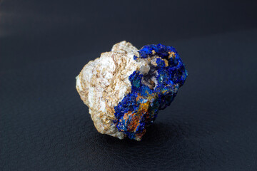 Macro blue azurite cluster on white matrix isolated crystal on black background 