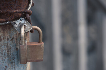 Two locked padlocks and cage bars