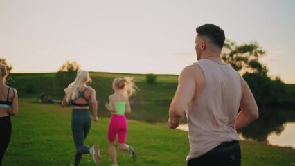 three blonde ladies with ideal bodies are running on grass, sporty man is running behind women