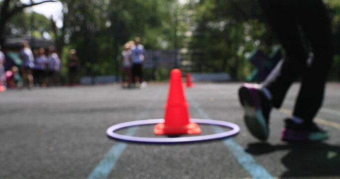 boys and girls of school age run chasing on the sports ground. The concept of healthy parenting. Children's sports competitions. blurred focus