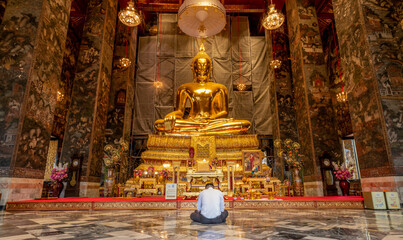 Giant Buddha sculpture at landmark Buddhist temple at Wat Suthat in Bangkok