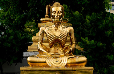 Golden statue at landmark Buddhist temple at Wat Suthat in Bangkok