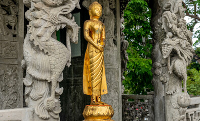 Fototapeta na wymiar Golden statue at landmark Buddhist temple at Wat Suthat in Bangkok