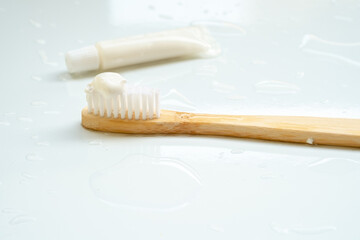 Eco-friendly toothbrush with wooden bamboo handle.