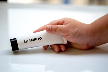 Obraz premium tube containing liquid shampoo with a stone texture and soap foam background