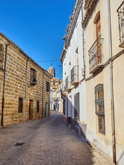 Cobblestone allley in Baeza, with a view of the Cathedral tower. Jaen province, Andalusia, Spain, Europe