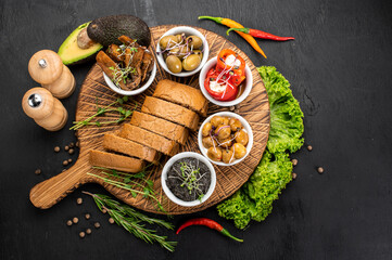 Dish with assorted marinated vegetables on wooden background