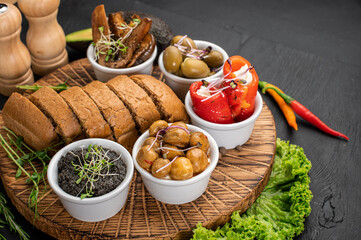 Dish with assorted marinated vegetables on wooden background