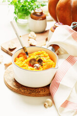 Pumpkin puree mashed with mushroom in a white bowl.