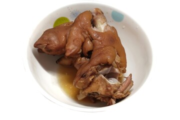 Pork knuckle, pork trotters, boiled, stewed until tender, placed in a white bowl