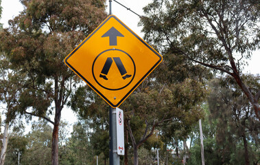 pedestrian sign amongst trees