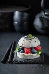 Unique sushi burger with berries and mascarpone as Japanese cuisine.