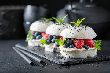 Delicious sushi burger with berries and mascarpone sprinkled with seeds.