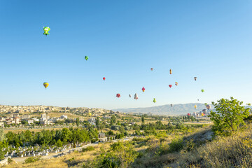 Göreme village, Nevsehir, Nevsehir Merkez, Cappadocia, Turkey - 07.28.2022: Hot air balloon launch over Cappadocia, hot air balloon parade