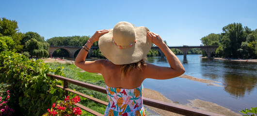 woman holiday maker looking at Dordogne river