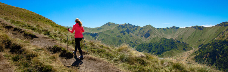 Hiker woman walking to the top of mountain- Puy de Sancy,  Auvergne in France
