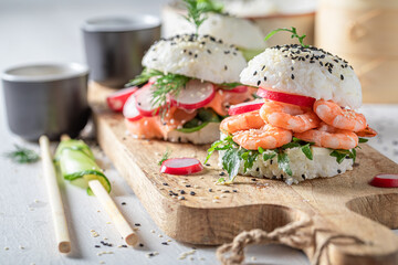 Unique sushi burger with seafood and rice as Japanese appetizers.