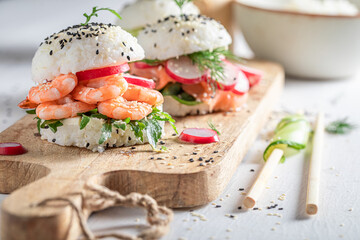 Exquisite sushi burger with avocado and salmon as Japanese appetizers.