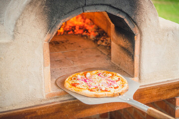 Delicious pizza from a hot outdoor stone oven