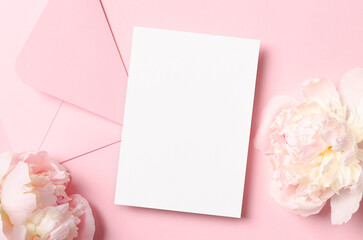 Greeting or invitation card mockup with envelope and pink peony flowers