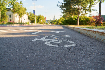 Cycling path in the park. Bicycle traffic sign painted on the floor