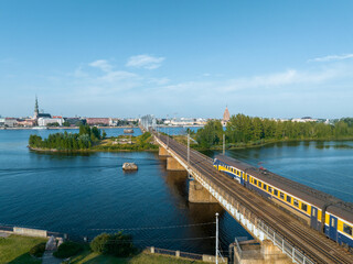 Train crossing river Daugava in Riga, Latvia. Beautiful aerial view of Riga.
