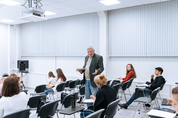 A gray-haired professor of mathematics in college teaches classes in higher mathematics, he walks...