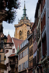 Colmar, Alsace, France, 4 July 2022: town capital of Alsatian wine, narrow picturesque street with medieval colorful houses, Timber framing or post-and-beam construction, romantic city at summer day