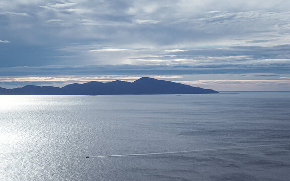 Kapiti Island, Wellington, New Zealand.

Dense cloud cover over Kapiti Island on a beautifully still summer evening. The sun sets as a boat passes by in the foreground.