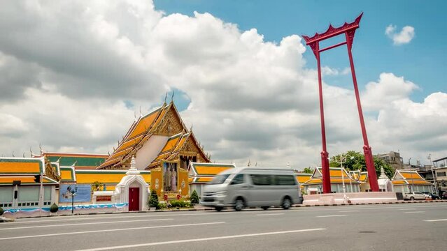 Time lapse of traffic in front of Wat Suthat Buddhist Temple in Bangkok with landmark giant red swing