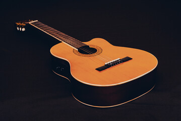 Six-string acoustic guitar on a dark brown background. Classical Spanish guitar. Musical...
