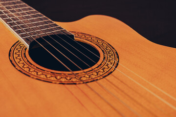 Rosette and strings of an acoustic guitar close up. Classical Spanish guitar. Musical instrument.