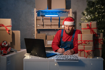 Small business aspiring entrepreneur Santa Claus, SME freelance working in home office using...