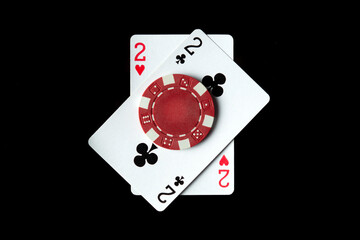 Poker game with one pair combination. Chips and cards on a black table in a poker club. Luck or fortune in the play