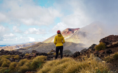 Obraz premium Main Crater. Tongariro National Park, Waikato, New Zealand.View of the main crater in the Tongariro National Park. Cloud rolls in over the terrain as sun pours into the valley below.