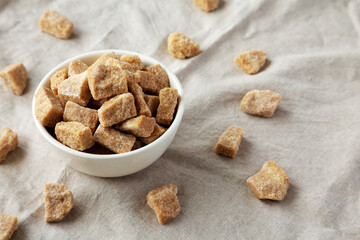 Raw Organic Demerara Granulated Brown Sugar in a Bowl, side view.