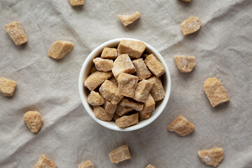 Raw Organic Demerara Granulated Brown Sugar in a Bowl, top view. Flat lay, overhead, from above.
